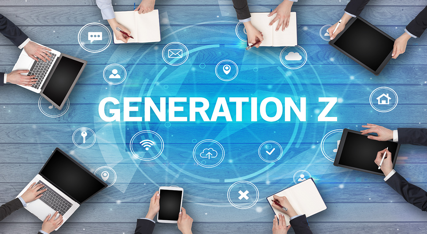 8 pairs of hands sit around a conference table with notepads and laptops with white text in the middle of them reading "GENERATION-Z"