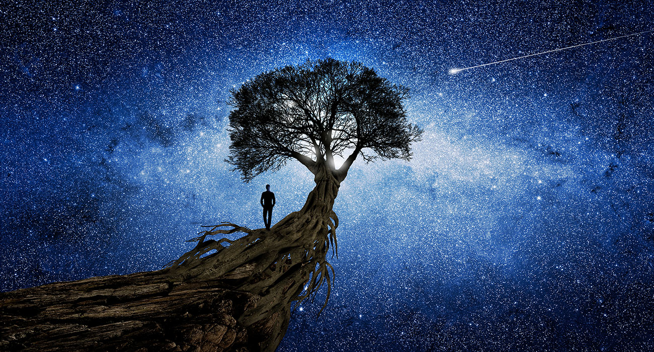 figure standing on tree extending into outer space